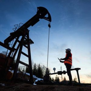 silhouette-of-a-worker-and-an-oil-pump-jack-on-the-sunset-agains-beautiful-sky.jpg